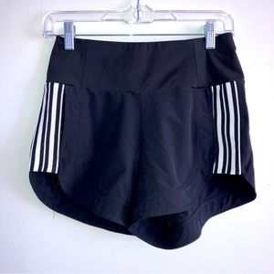 Athleta Black running shorts with wide waistband and back zipper pocket.